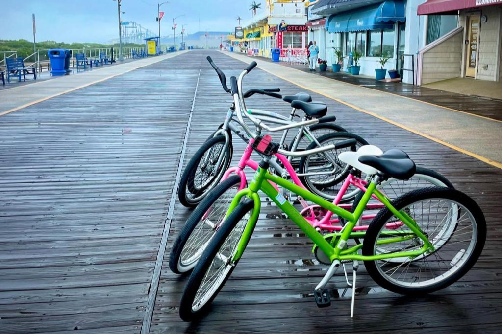 Bicycles lined up along the boardwalk, offering an easy way to explore the nearby shoreline and local shops. A relaxed outdoor scene that captures the casual coastal pace and encourages scenic rides along the waterfront.