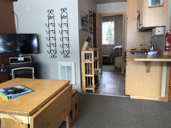 Livingroom area leading to kitchen, bathroom & bedroom.