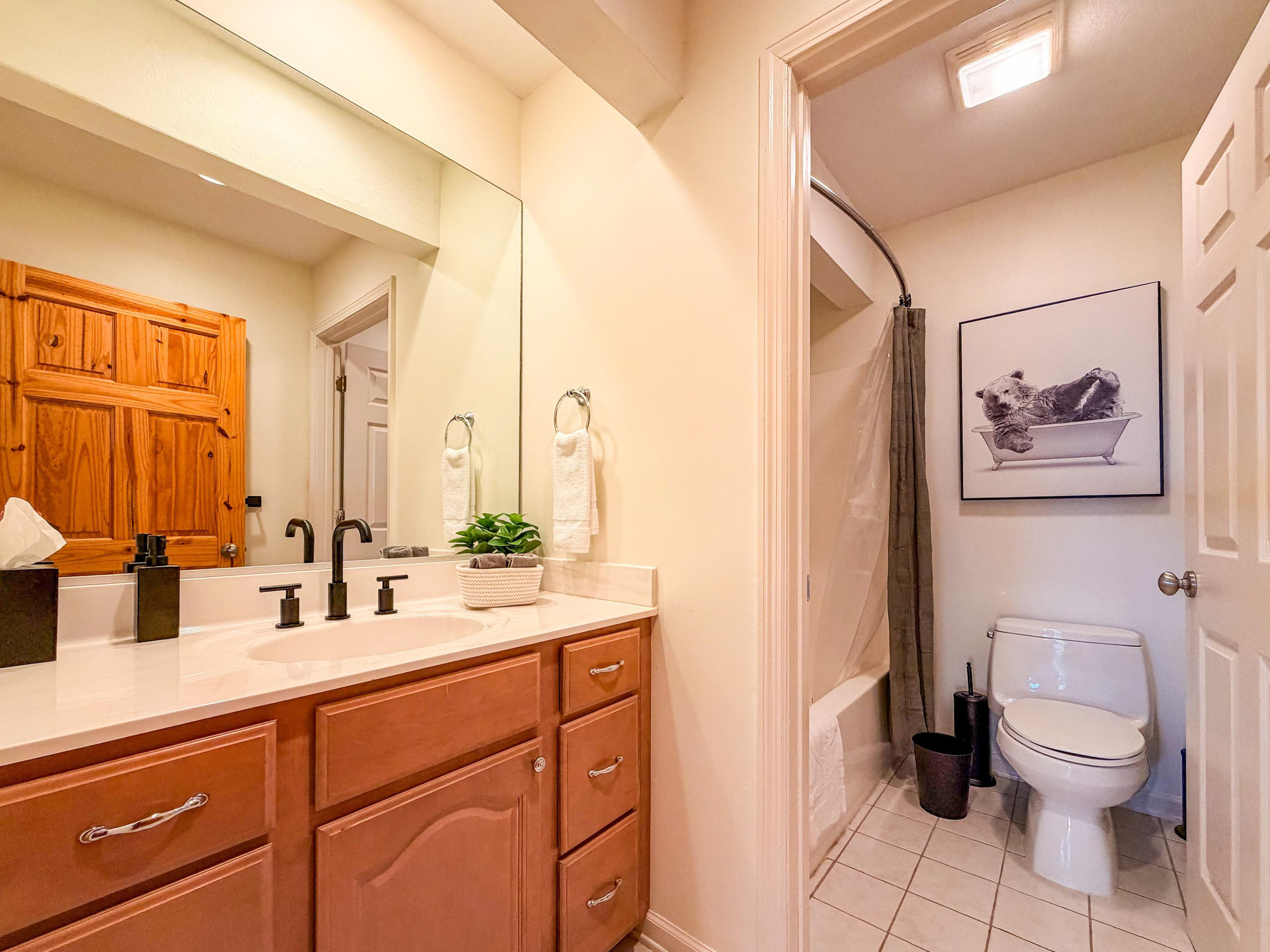 This upstairs bathroom is conveniently located between the guest bedroom and the bunk room. It is a full bathroom featuring a tub/shower combination.