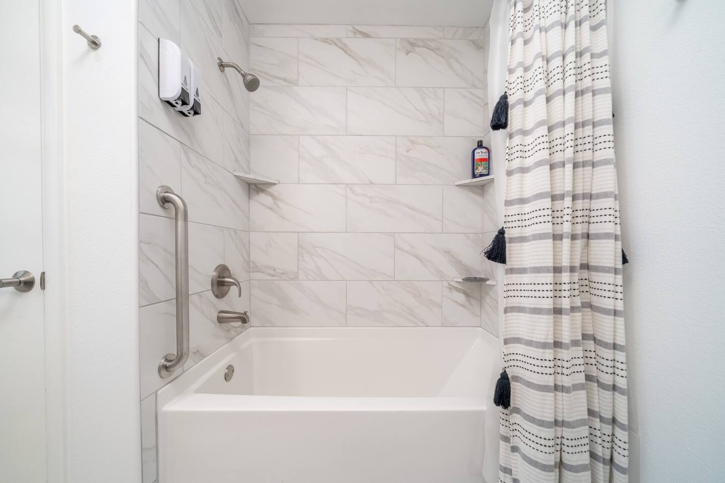 Bathroom with shower and tub with  Luxury towels, body wash and shampoo.