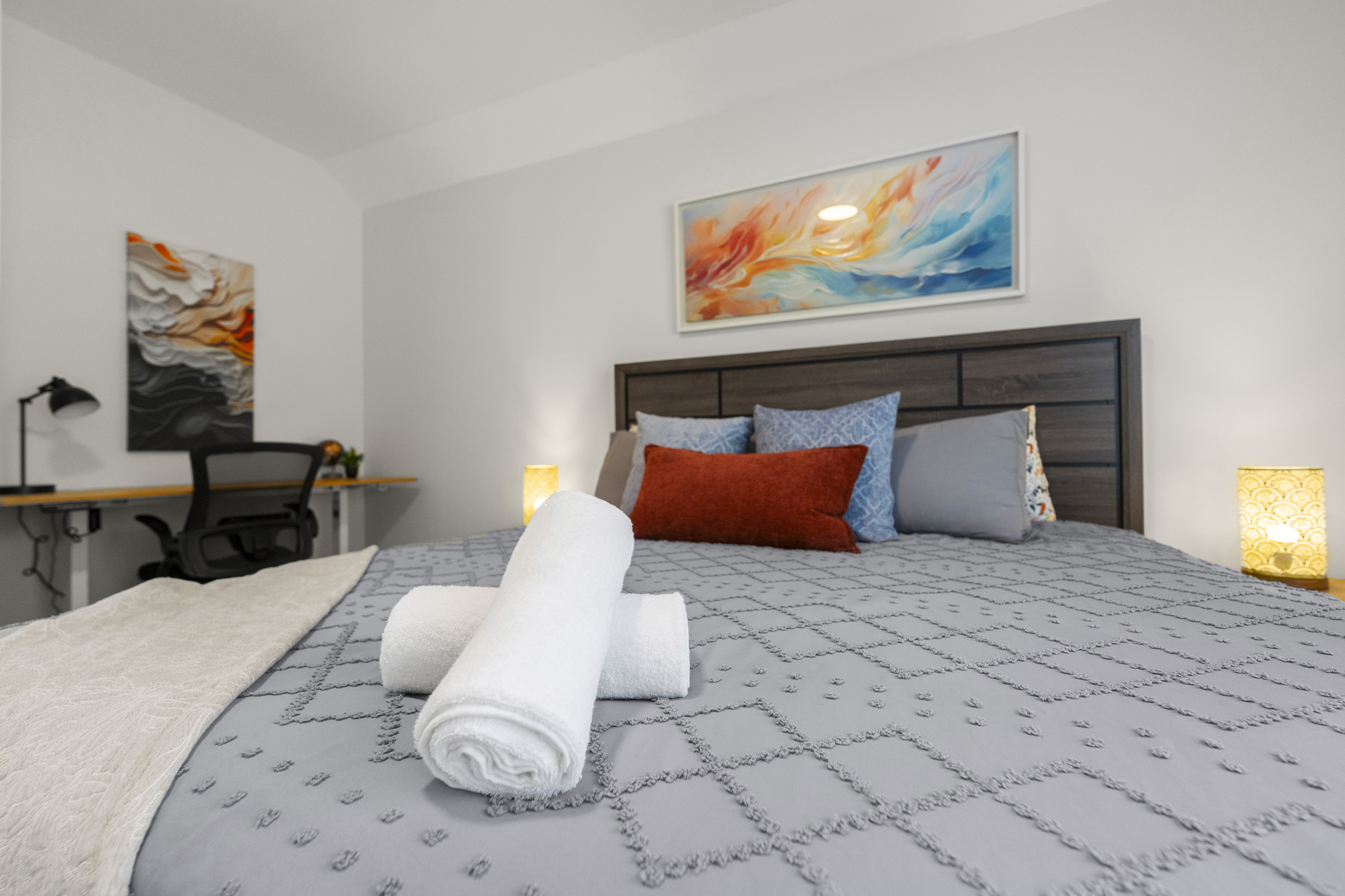 A warm and welcoming bedroom with soft lighting and a relaxing atmosphere.