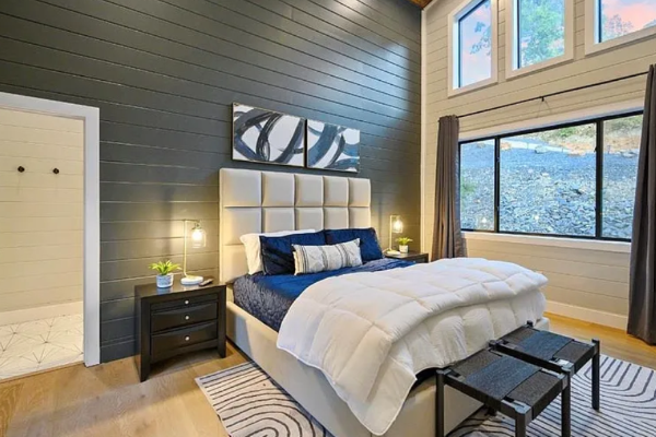 Comfortable bedroom with modern décor and ample natural light.