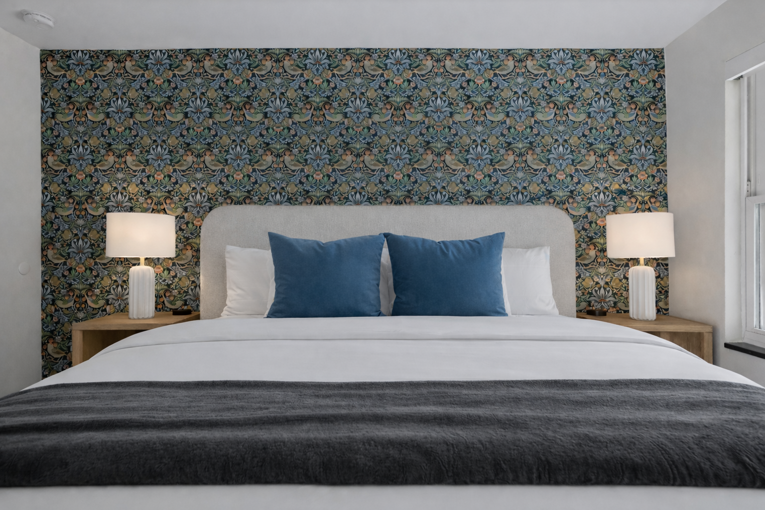 Stylish bedroom retreat with a plush bed, bold accent wall, soft lighting, and hotel-quality comfort for a truly relaxing stay.