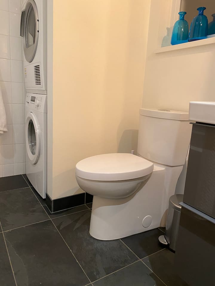 Bosch laundry machine and dryer in the corner beside toilette
The heated Slate tiles are 12”x24”