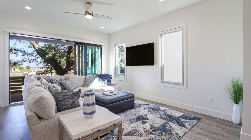 Luxurious and Modern Beach House Living Room with Doors Leading Out Toward the Beach