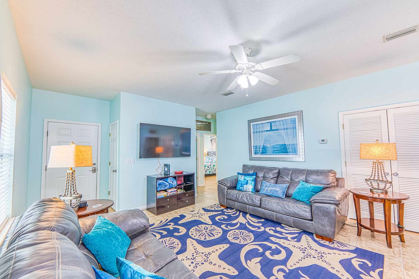 Living Room: Bright and airy space with beachy decor, perfect for relaxation after a sun-soaked day!