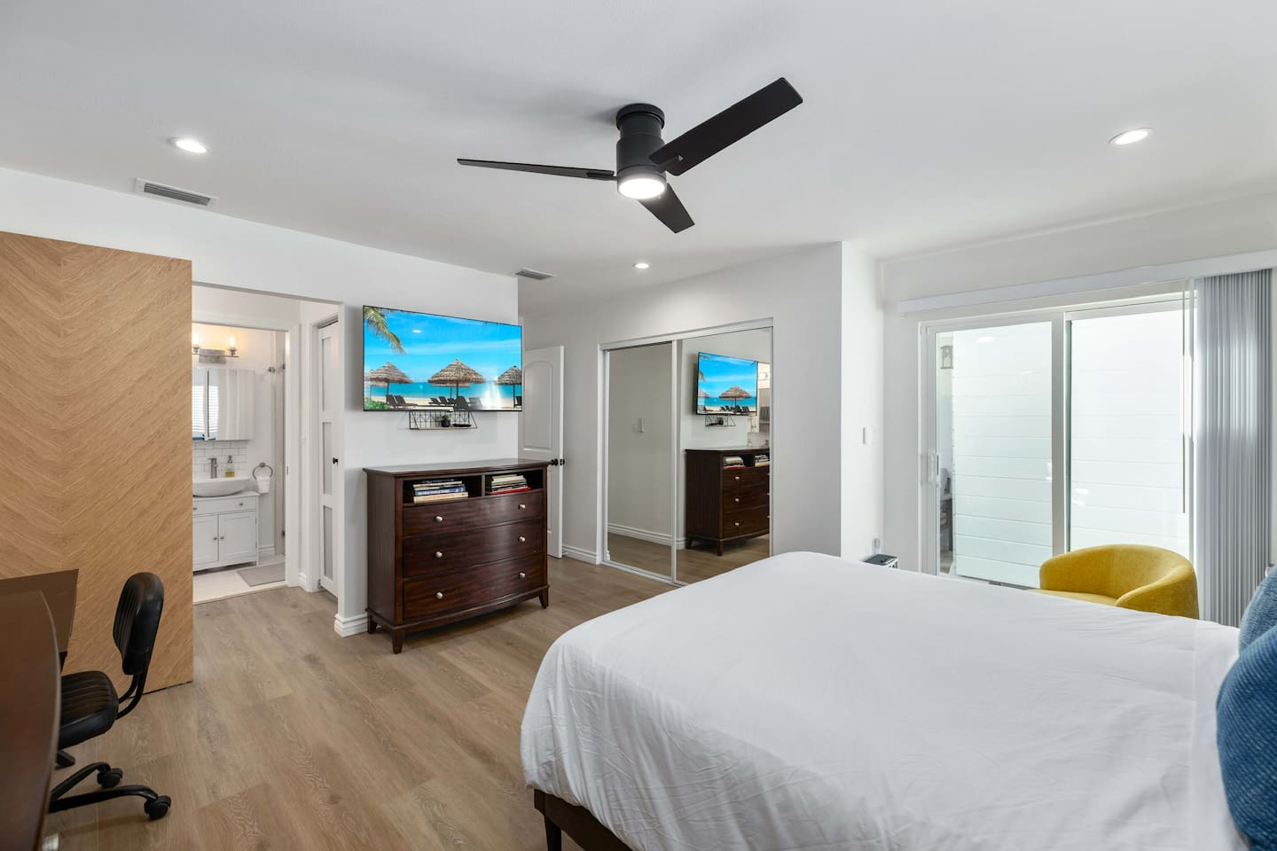 Large Master Bedroom 1 with two closets, desk and slider door to patio and backyard.