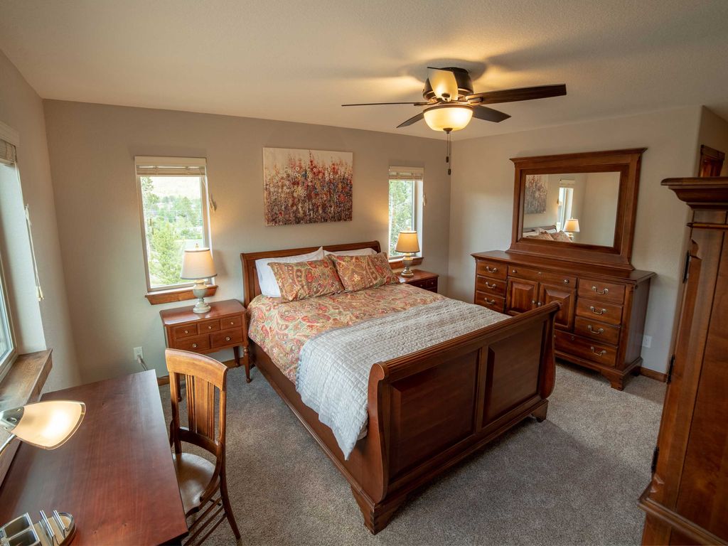 Upstairs Bedroom 3 Spacious queen bedroom featuring a dedicated work desk, ample storage, and elegant high-end furnishings—perfect for both relaxation and productivity during your stay!
