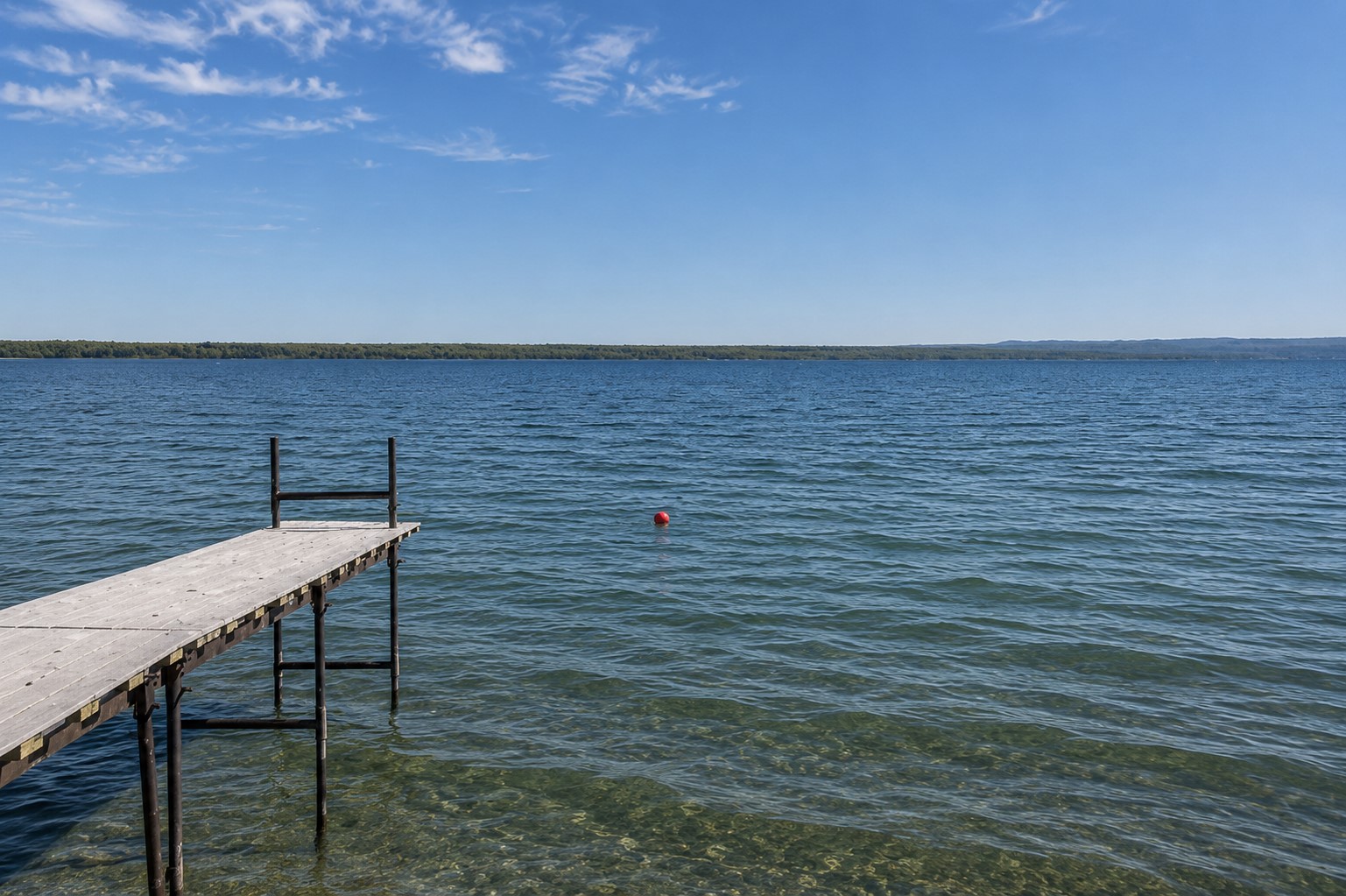 Peaceful lakefront views stretch for miles — perfect for morning coffee or sunset swims on your private dock.
