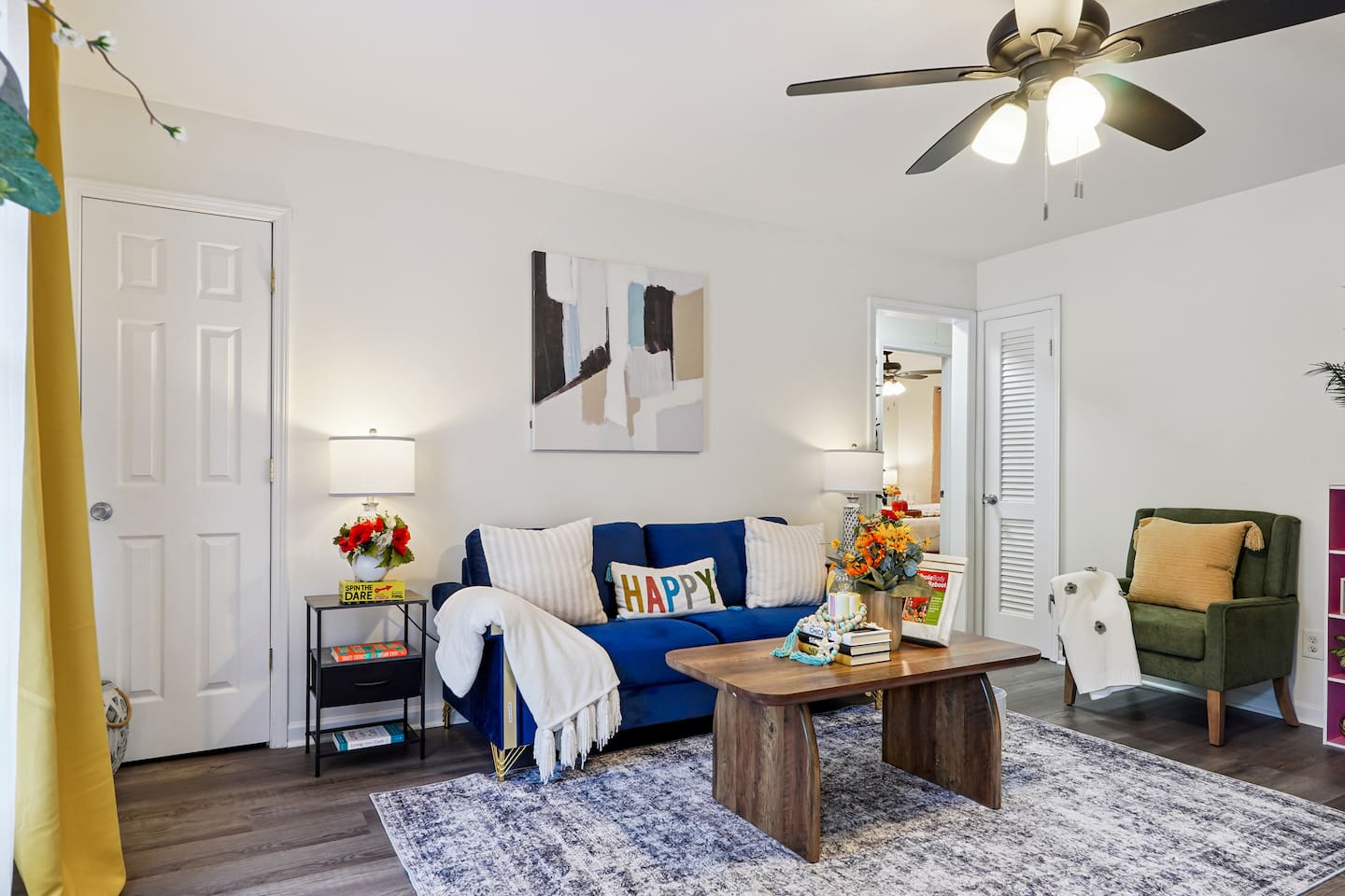 The living room features cozy furniture, including a comfortable blue couch, and an Amazon Fire-powered Smart TV for your entertainment. You’ll also find the Xfinity modem conveniently located here, convenient for ethernet connection.