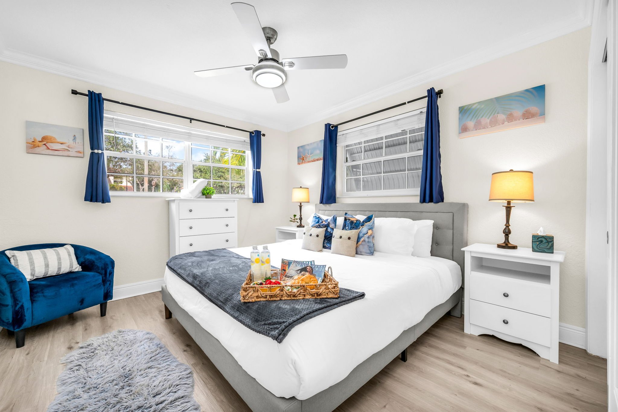 Unwind in the serene primary suite with a king bed, soft linens, and sunlit windows—your peaceful escape after a day at the beach.