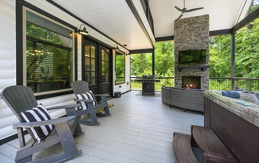 Outdoor living space with fireplace and comfortable seating.