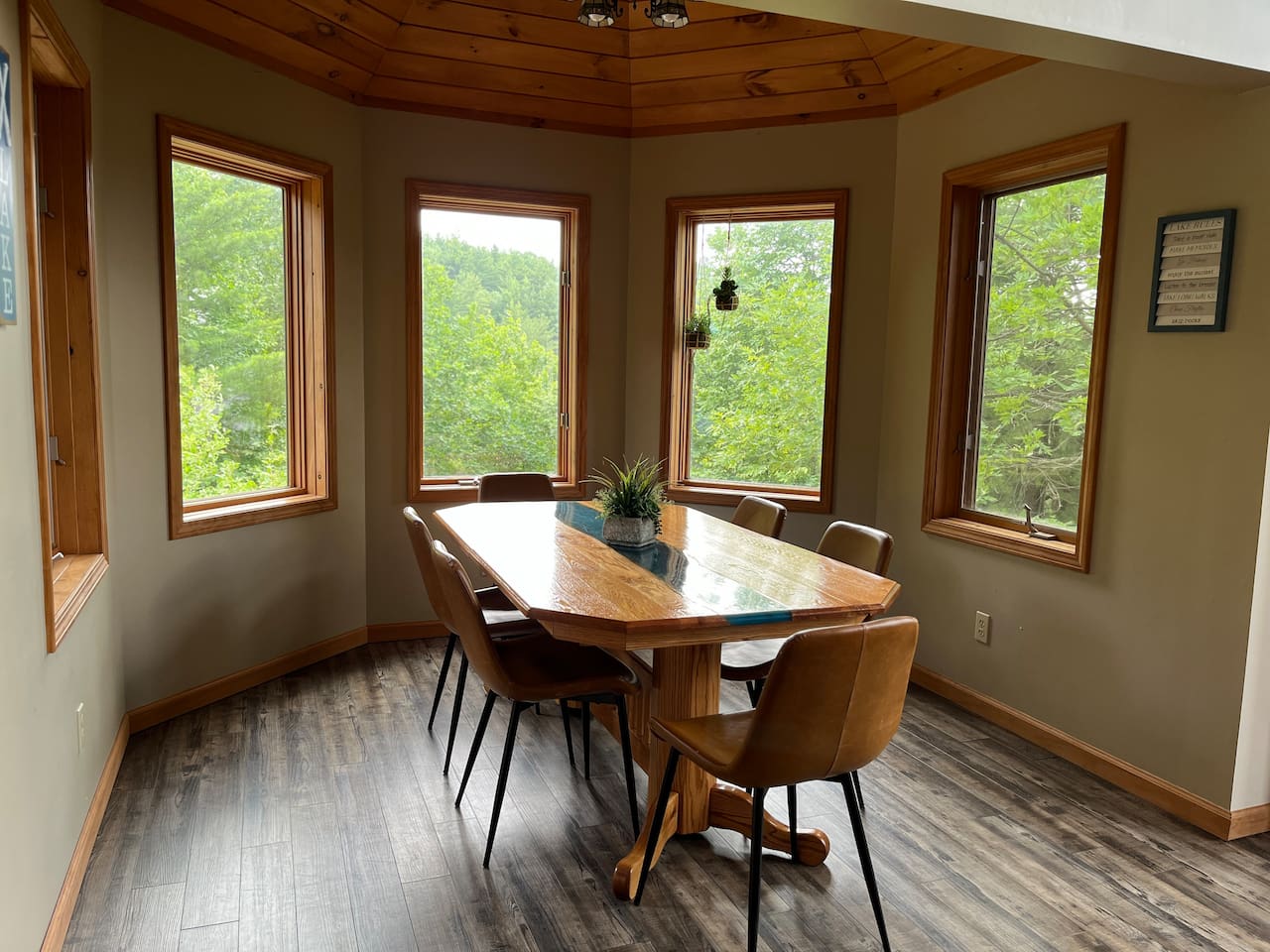 Dining for six around a beautiful river running wood table with panoramic view. 