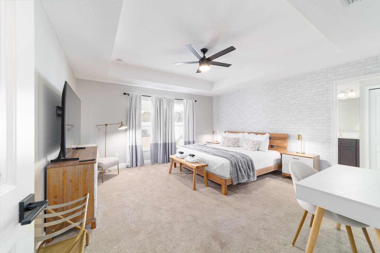 Relax in this bright and serene master suite featuring a plush king bed, cozy reading nook, Smart TV and a private bathroom. Soft tones, modern décor, and abundant natural light create the perfect space to unwind and recharge during your stay.