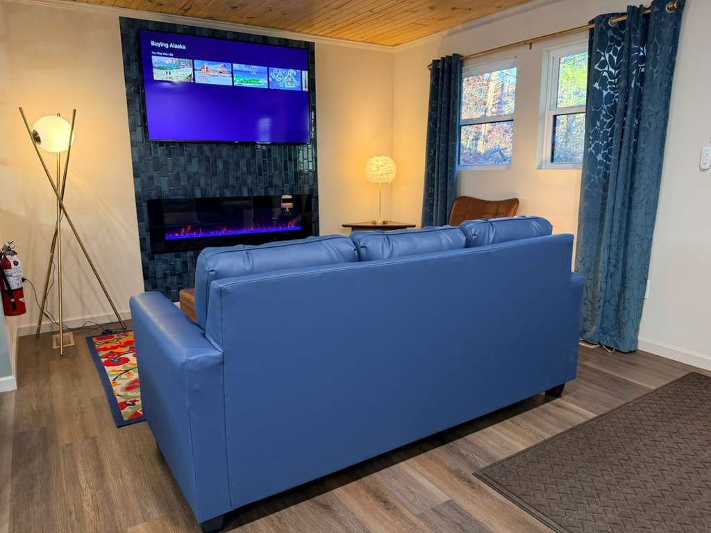 A bright and inviting space! Notice the warm wood plank ceiling that runs throughout the main level of the home.