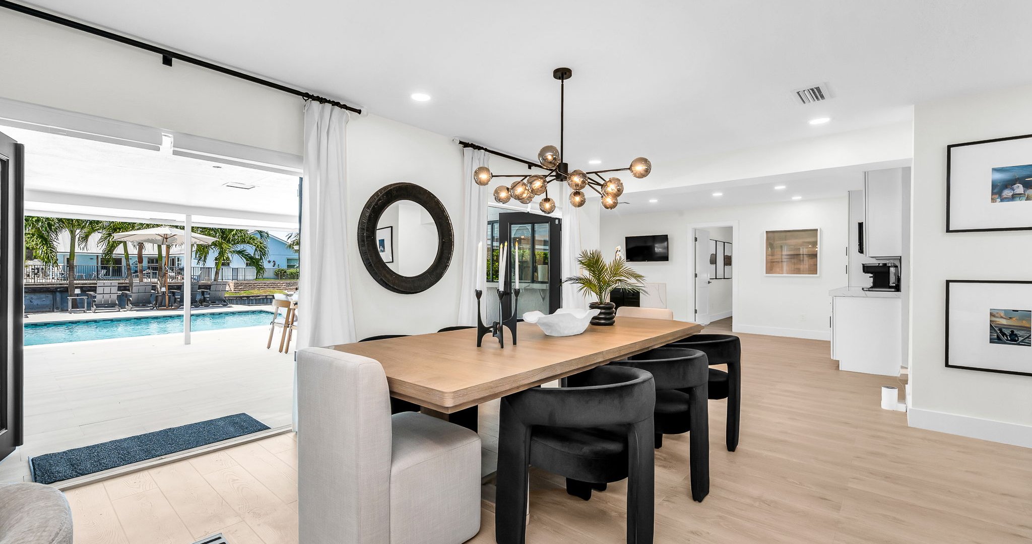 Experience resort-style dining with a designer table for 8 indoors and al fresco seating for 10 by the pool, offering an elegant backdrop for unforgettable gatherings