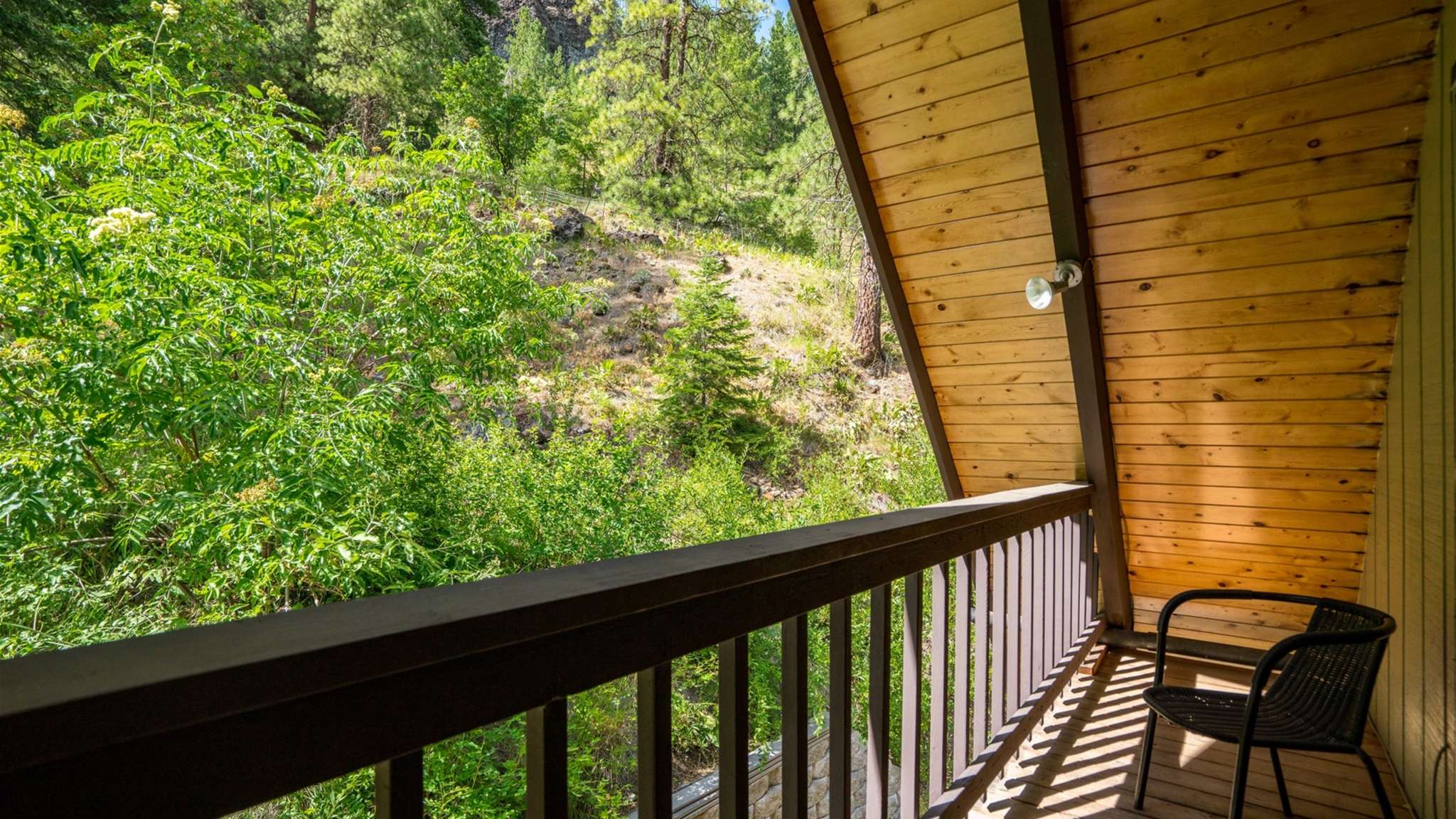 Private balcony overlooking the trees — the perfect morning coffee spot.
