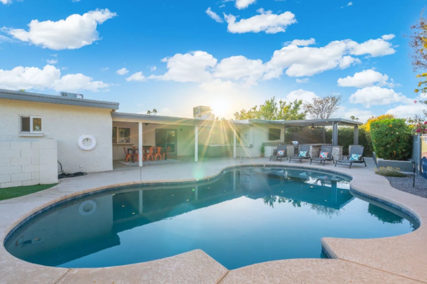Sunrise over the pool, with the whole backyard stretched out behind it — this is where mornings start slow and afternoons never do.