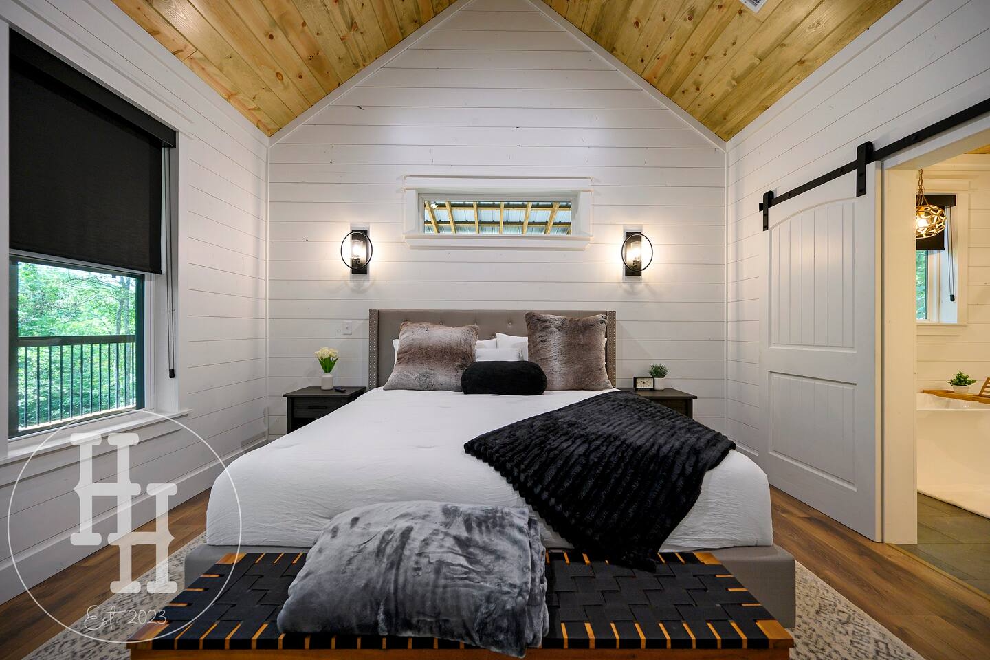 Master bedroom leading into the master bathroom. Smart TV, ceiling fan