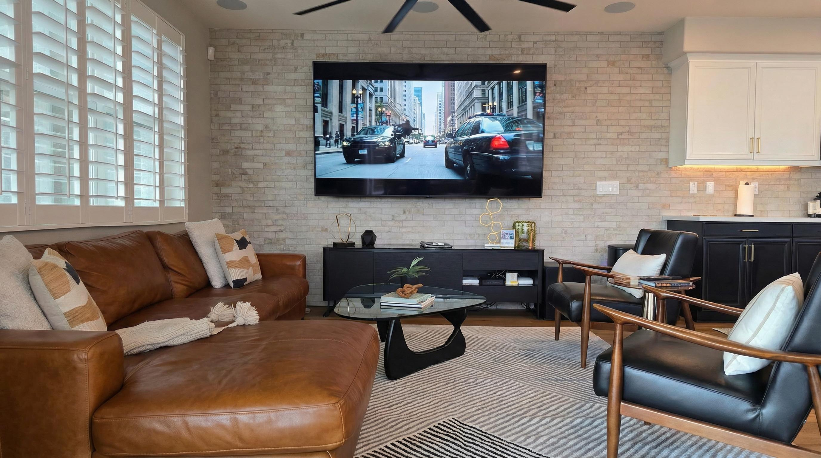 Plush Italian leather sofa & armchairs in the living room with an 87" HDTV.