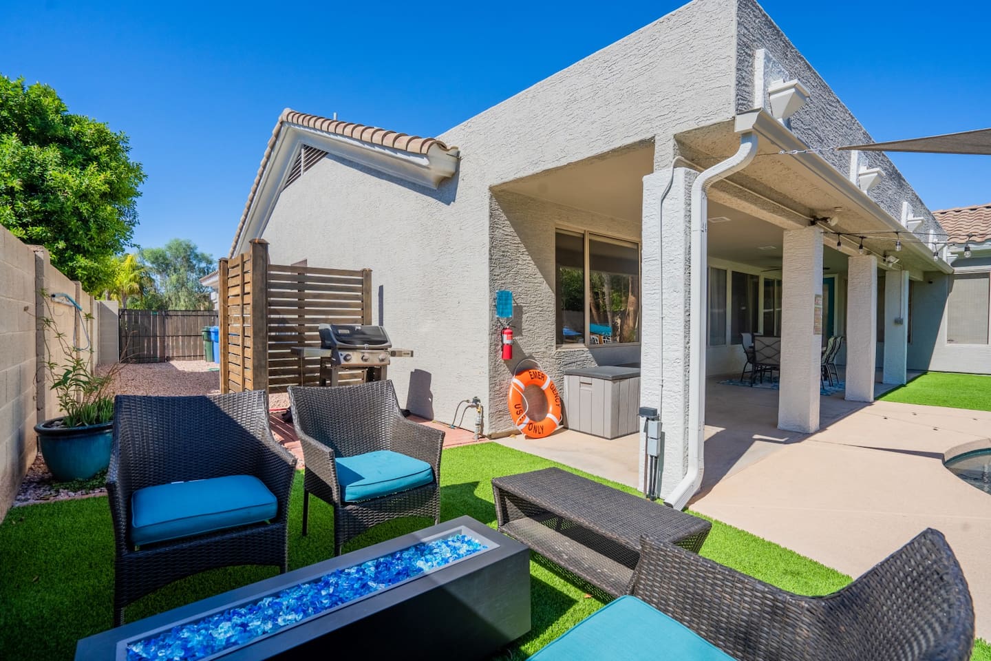 Comfortable chairs await you by the gas firepit.