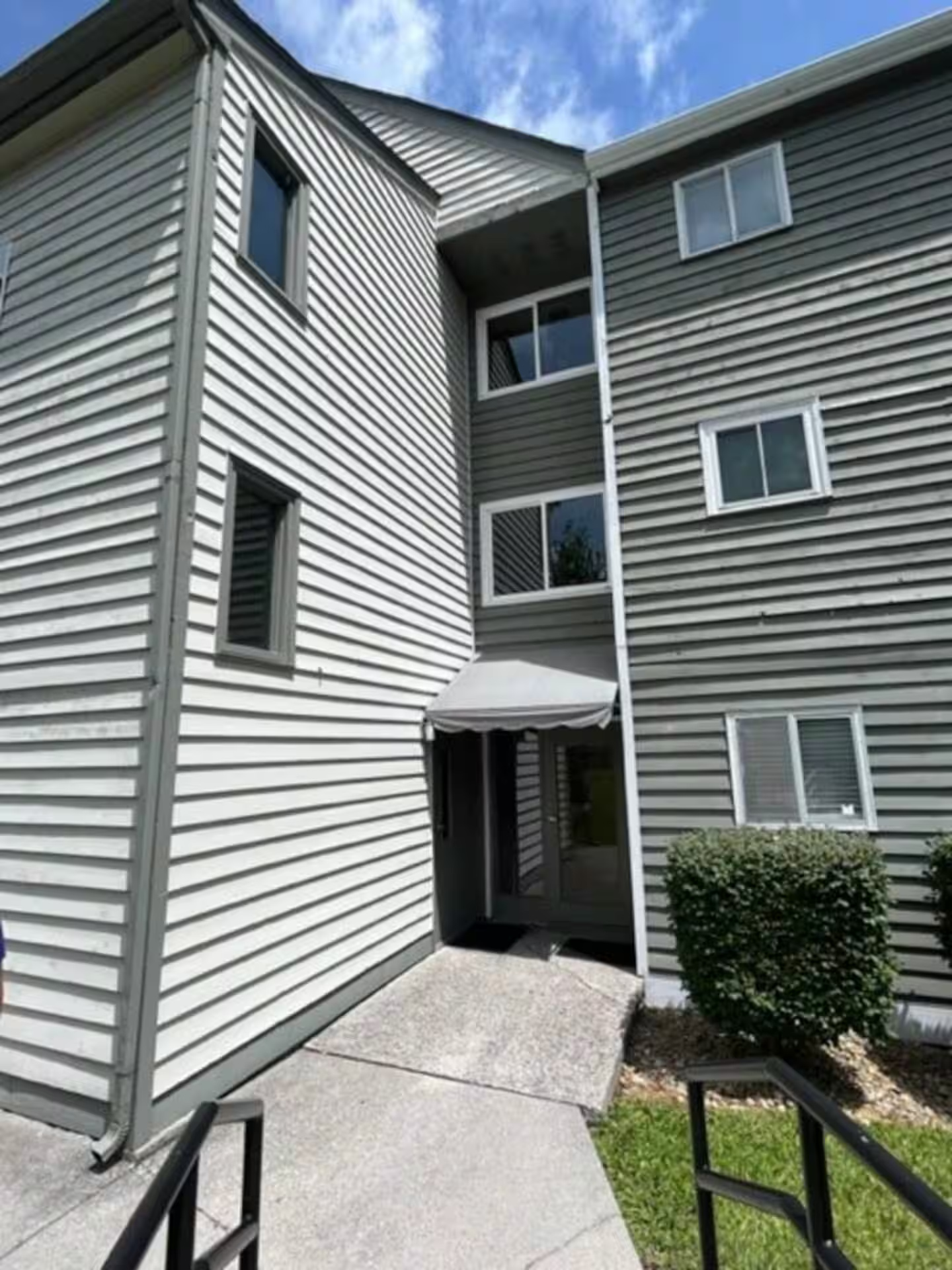 Enter the left side door under the awning