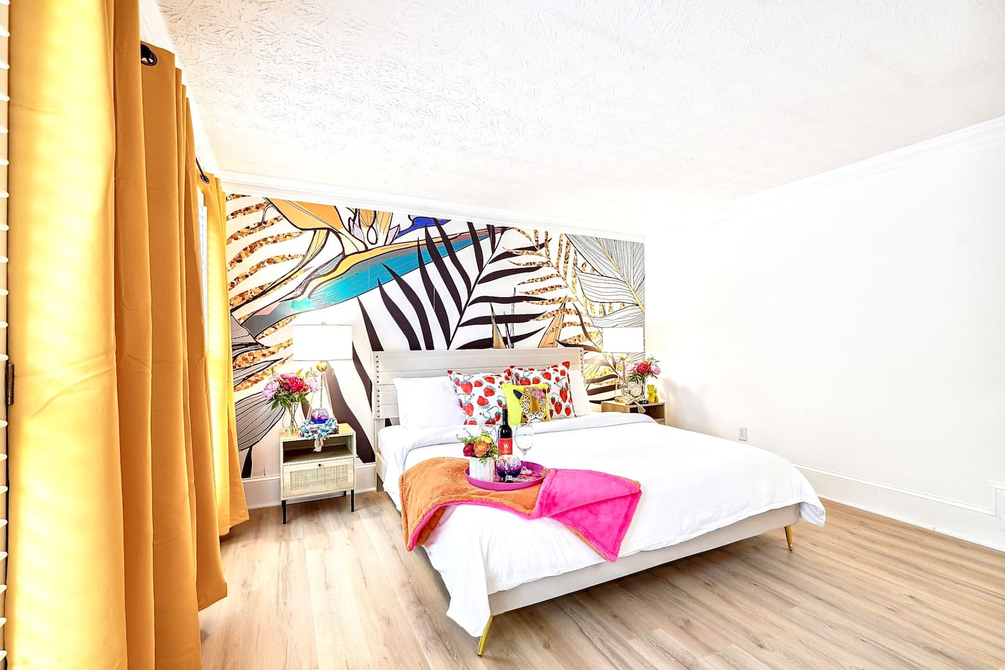 Bedroom 1 is located on the main level and features a king-size bed, TV, and a no ensuite bathroom. A nearby half bathroom is available for guest use.