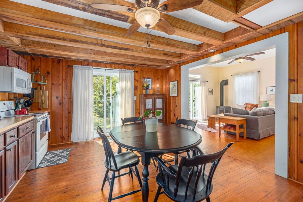 The well stocked kitchen is open to the living room, both of which have sliding glass doors to enjoy the outside even when you are inside.