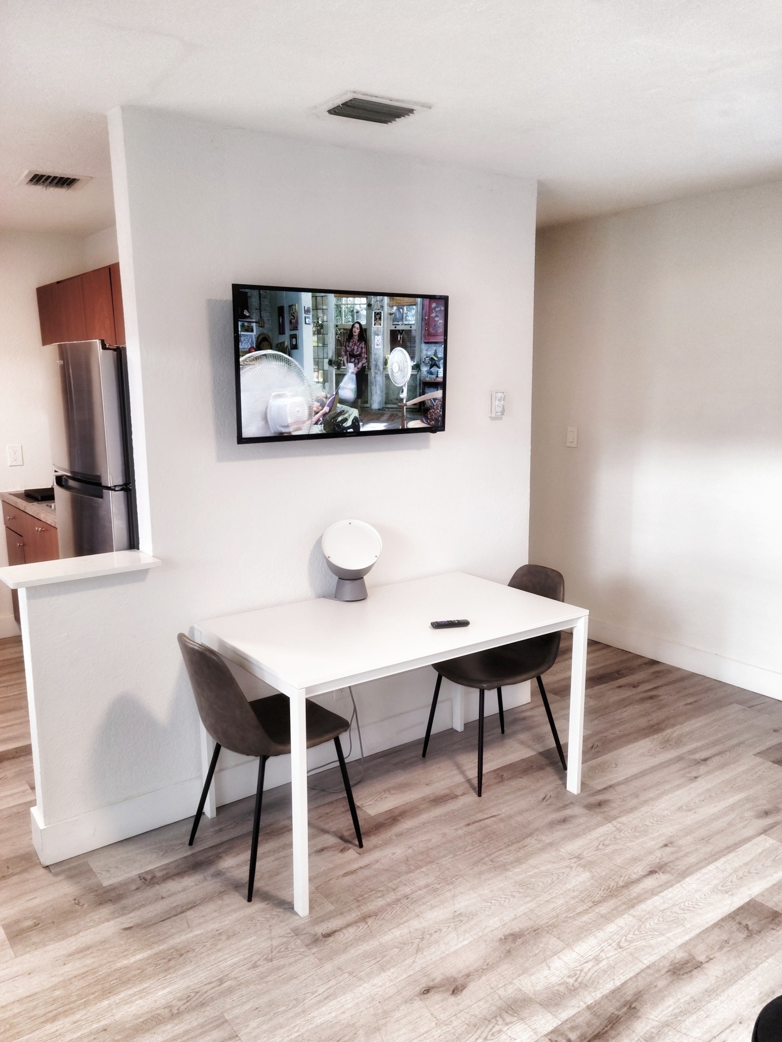 Roku TV for streaming. Dining table and chairs for two guests.