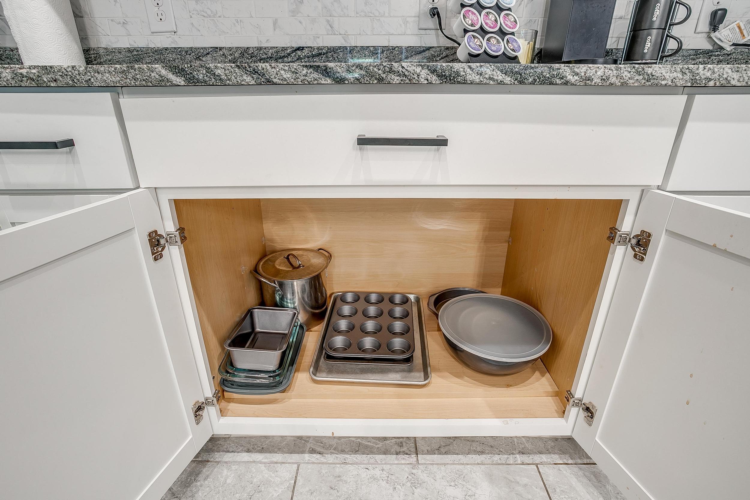 Cabinet drawer with cookware, trays, and bakeware included.