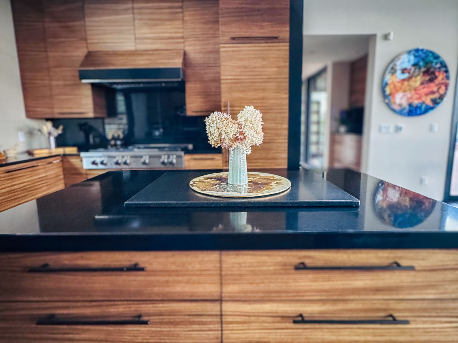 The Chef&rsquo;s Kitchen island at Sunset Falls &mdash; zebrawood cabinetry, black quartz, valley view, Berkshires