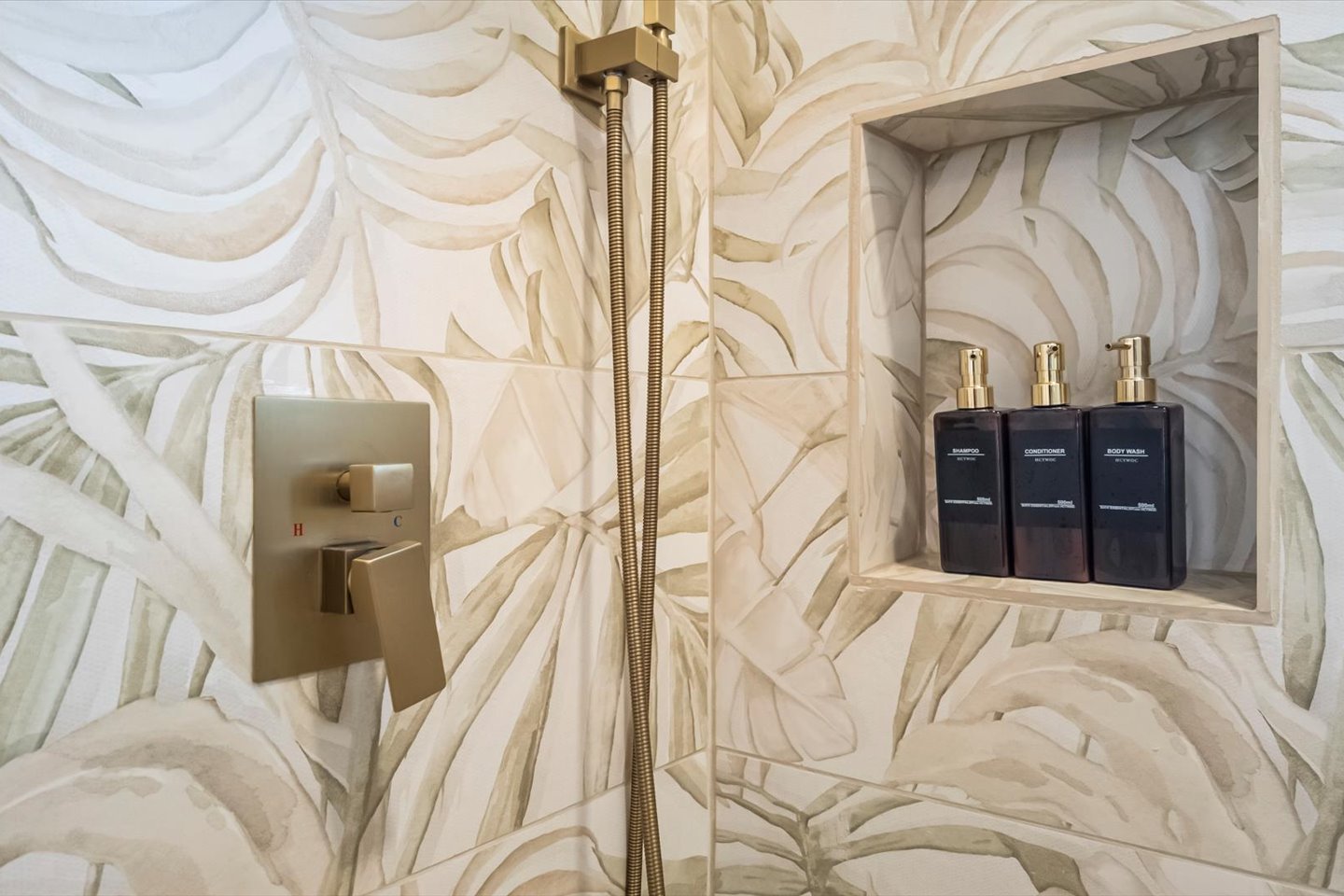 Shampoo, conditioner, body wash, and toilet paper are provided. 