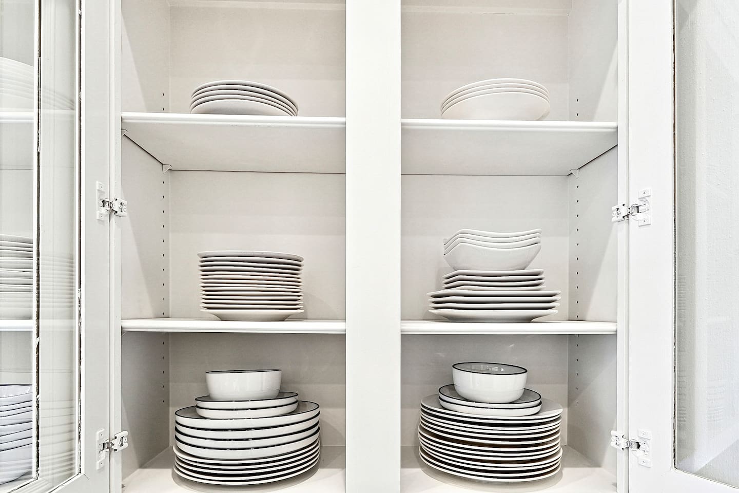 Bright and beautifully designed kitchen with white marble counters and white wood cabinetry. Fully equipped and ideal for cooking, gathering, and hosting with ease.