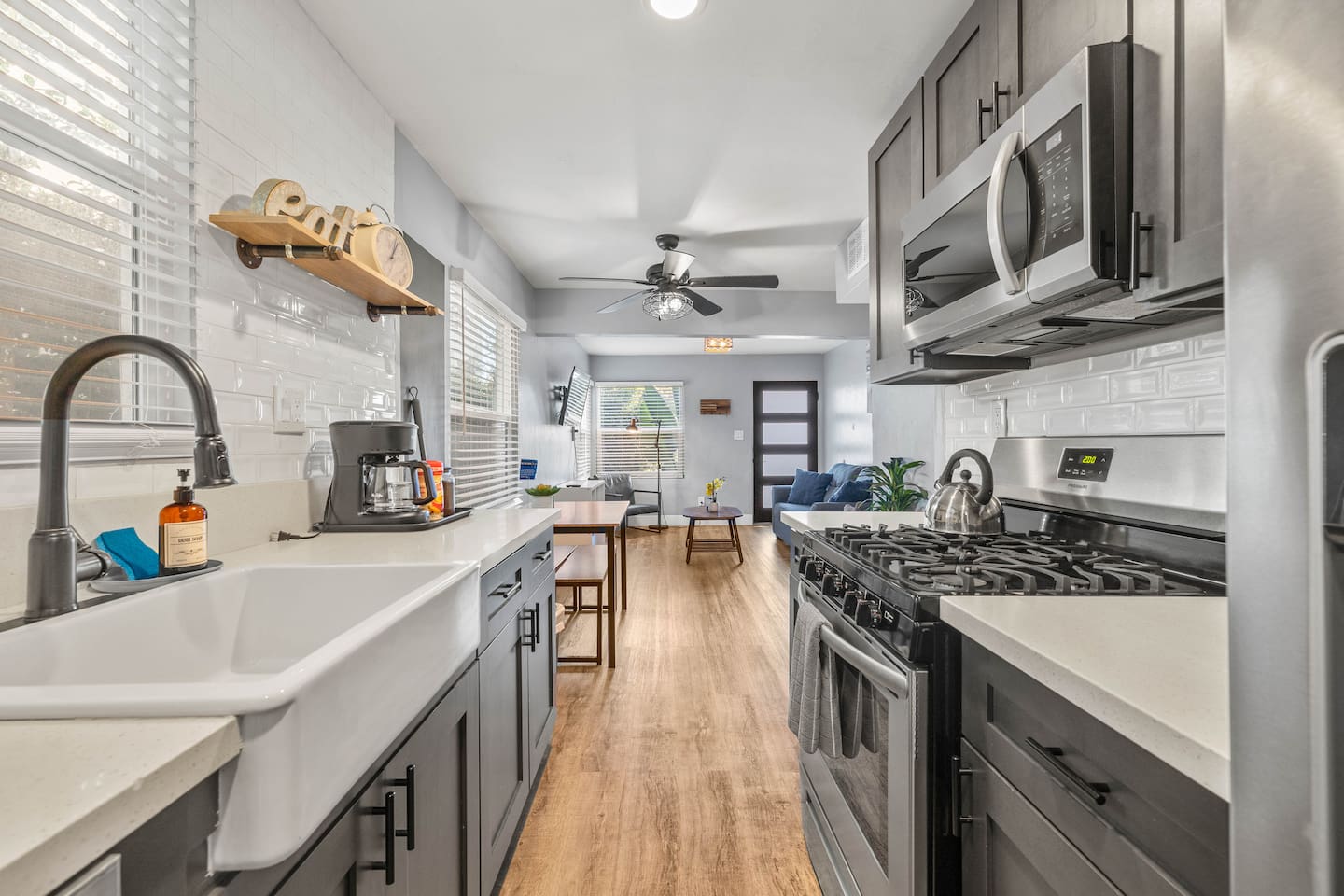 Experience culinary bliss in our spacious kitchen, featuring a modern sink, stove with oven, and stylish refrigerator. The inviting open layout provides views of the cozy dining table and living room, perfect for quality time!