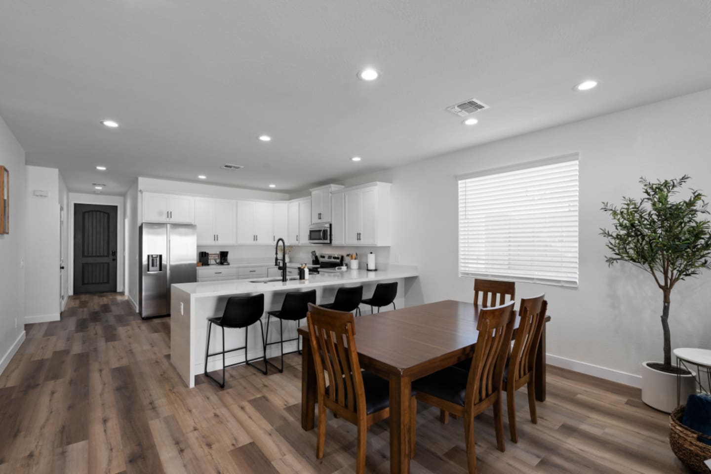 Dining area connected to the kitchen, with plenty of seating for meals or planning the day.