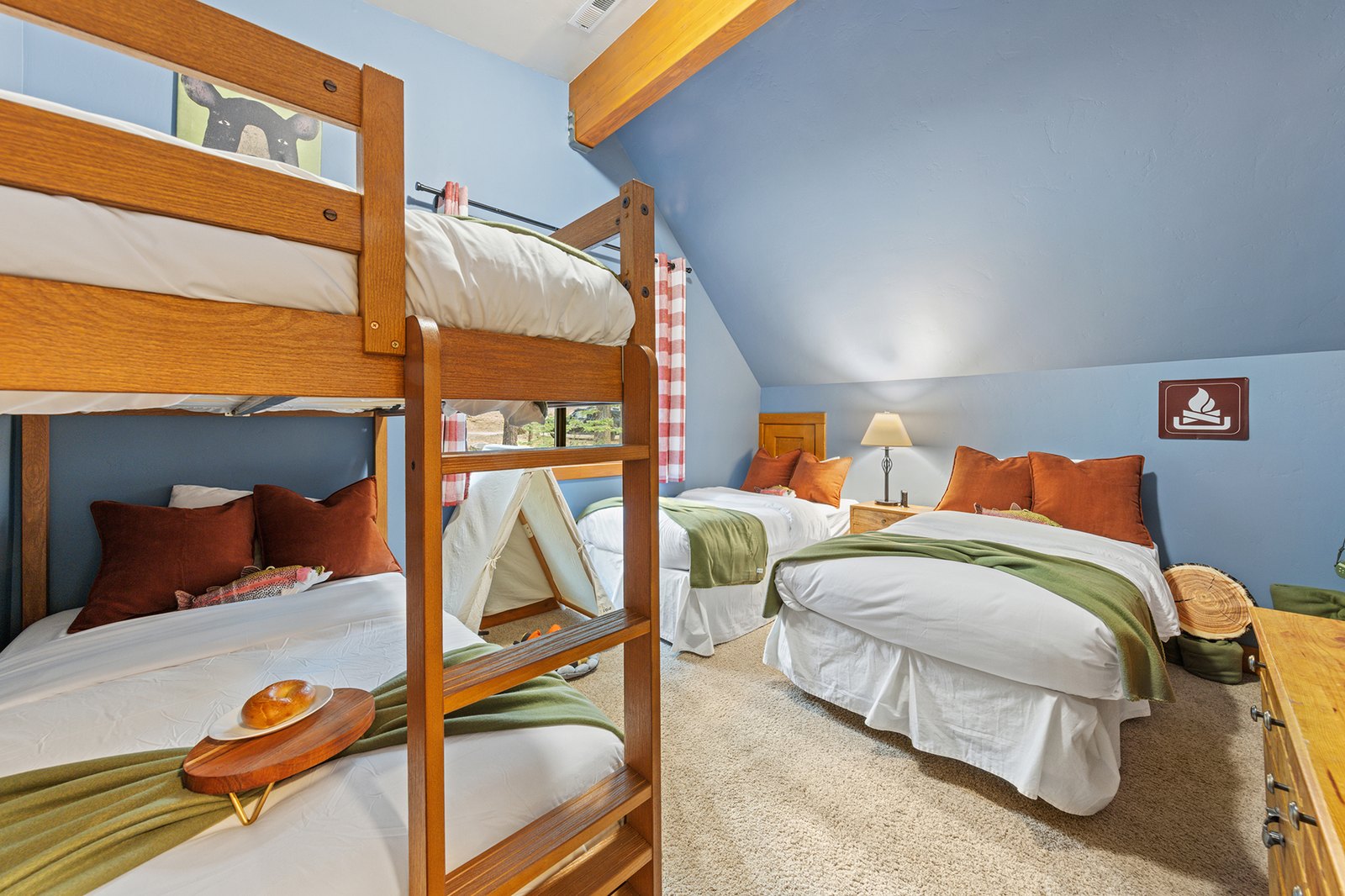 Hand the kids their own room — four beds, a play tent, and a little 'campfire' that makes this the highlight of the trip for them.