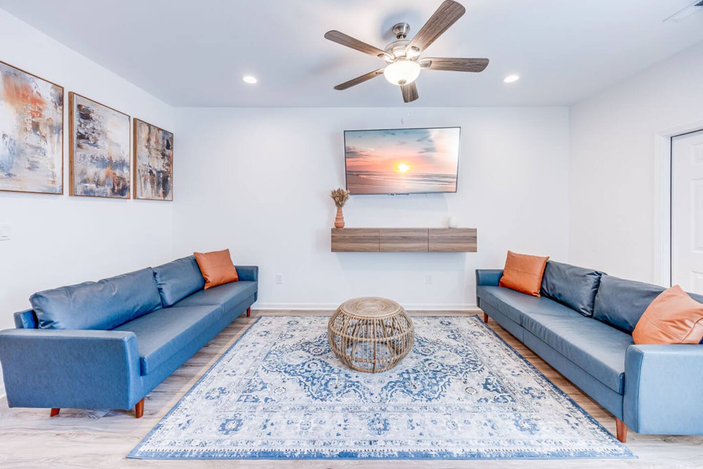 Cozy and inviting, this space features two couches on a stylish rug, centered around a TV for your entertainment.