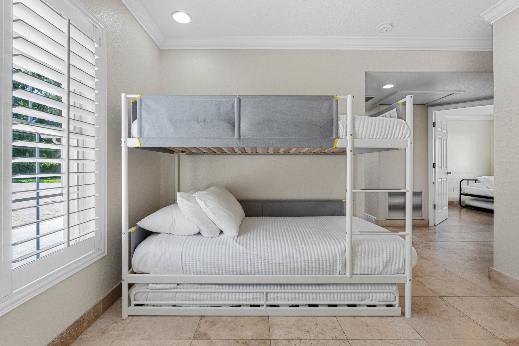 This bedroom is a cheerful and versatile space that’s perfect for children, teens, or additional guests needing a comfortable and convenient place to sleep.