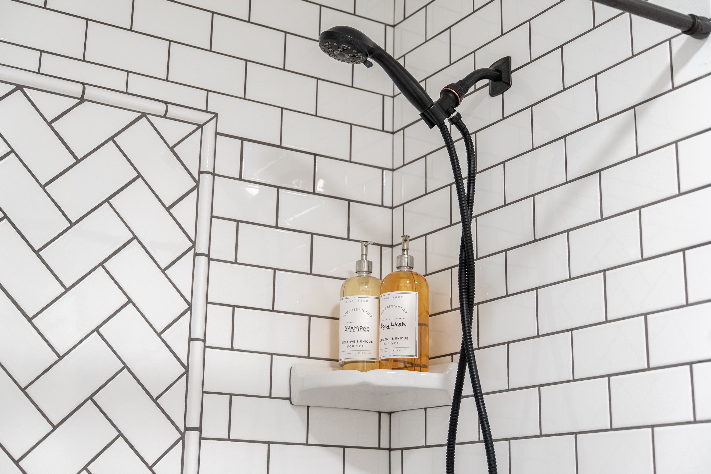 A clean and modern shower space fully stocked with premium essentials.