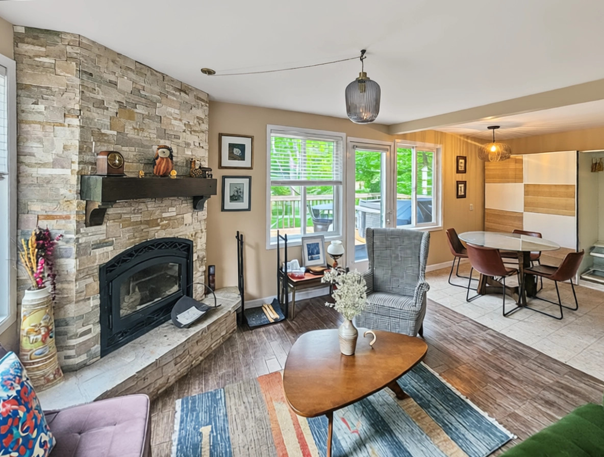View across living room showing dining area and balcony access door