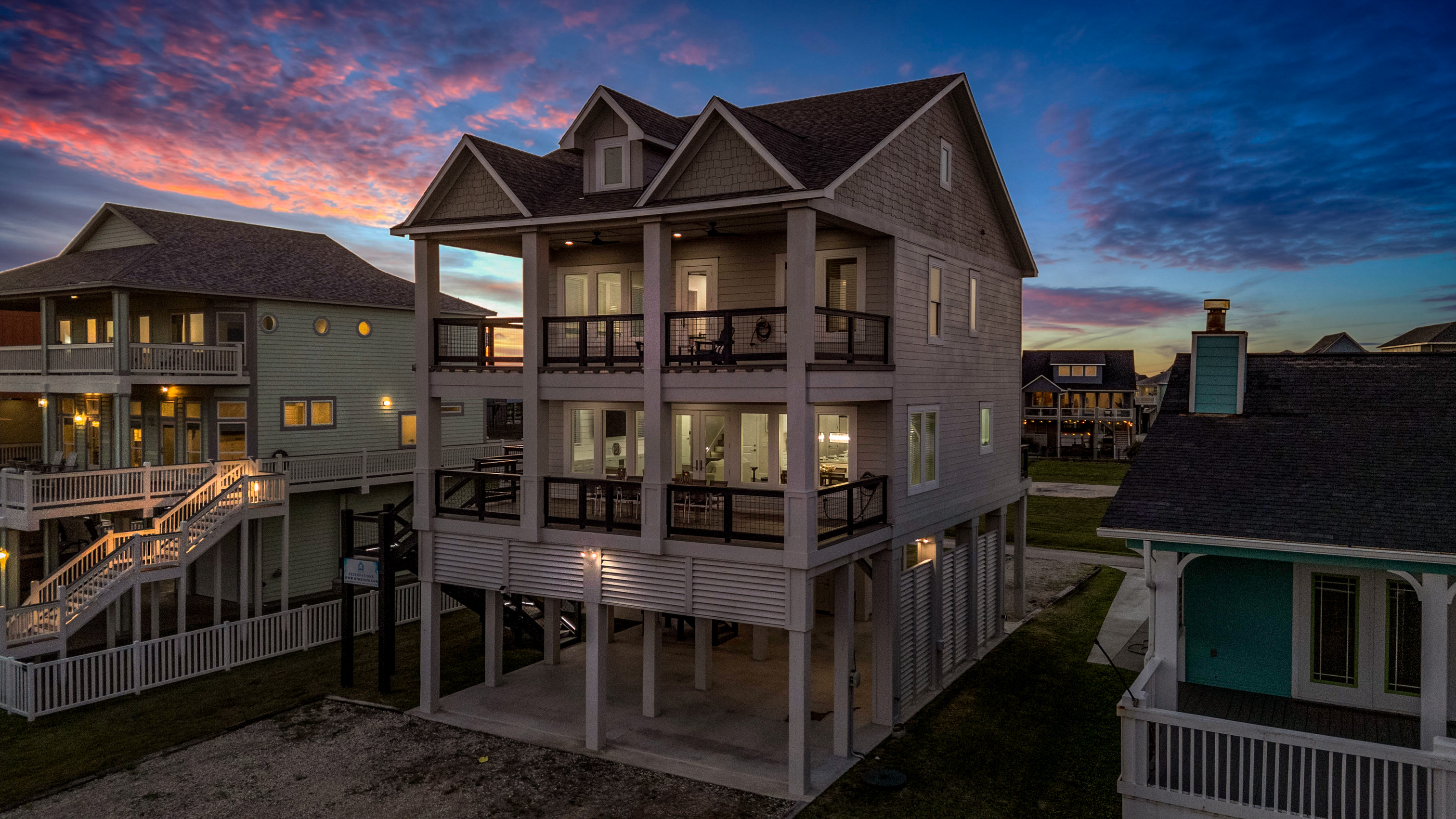 Costa Cristal Exterior: Experience the grandeur of this luxurious home, where striking architecture and clean lines create a bold, modern statement. Expansive terraces invite you to enjoy the views. 