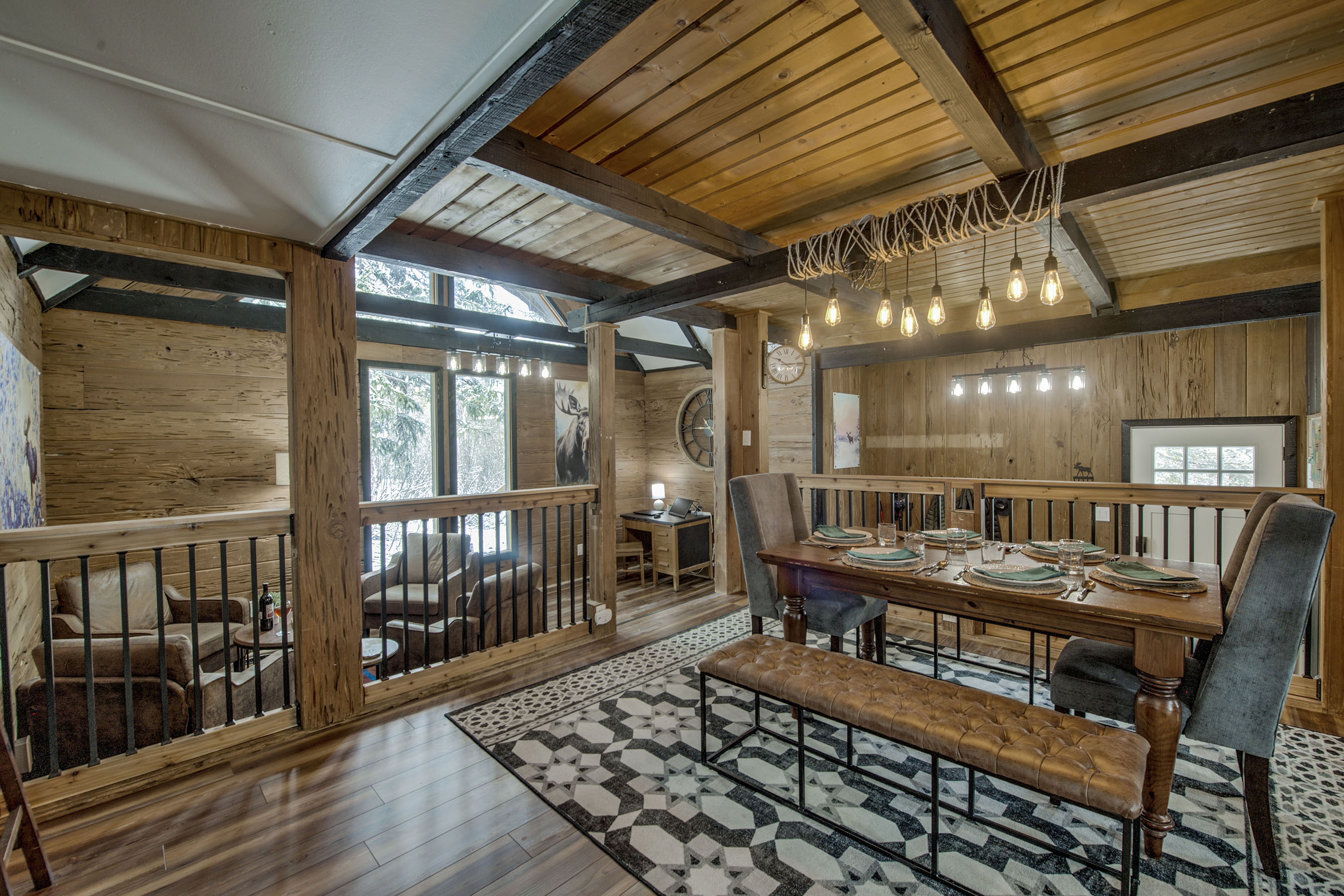 Gather in your warm dining room with exposed beams, soft lighting, and a table set for you and yours to savor meals and moments together.