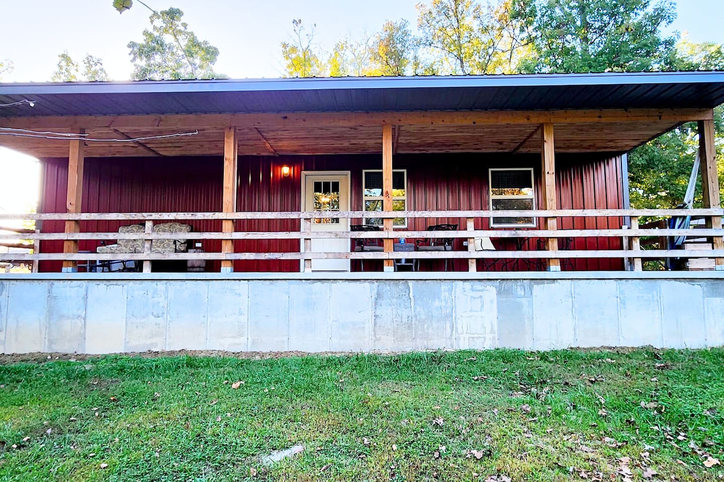 Enjoy your morning coffee or unwind after a day of adventure on this spacious covered porch—perfect for watching wildlife, swapping stories, or savoring the quiet. Plenty of seating invites you to linger longer in the beauty of the woods.









