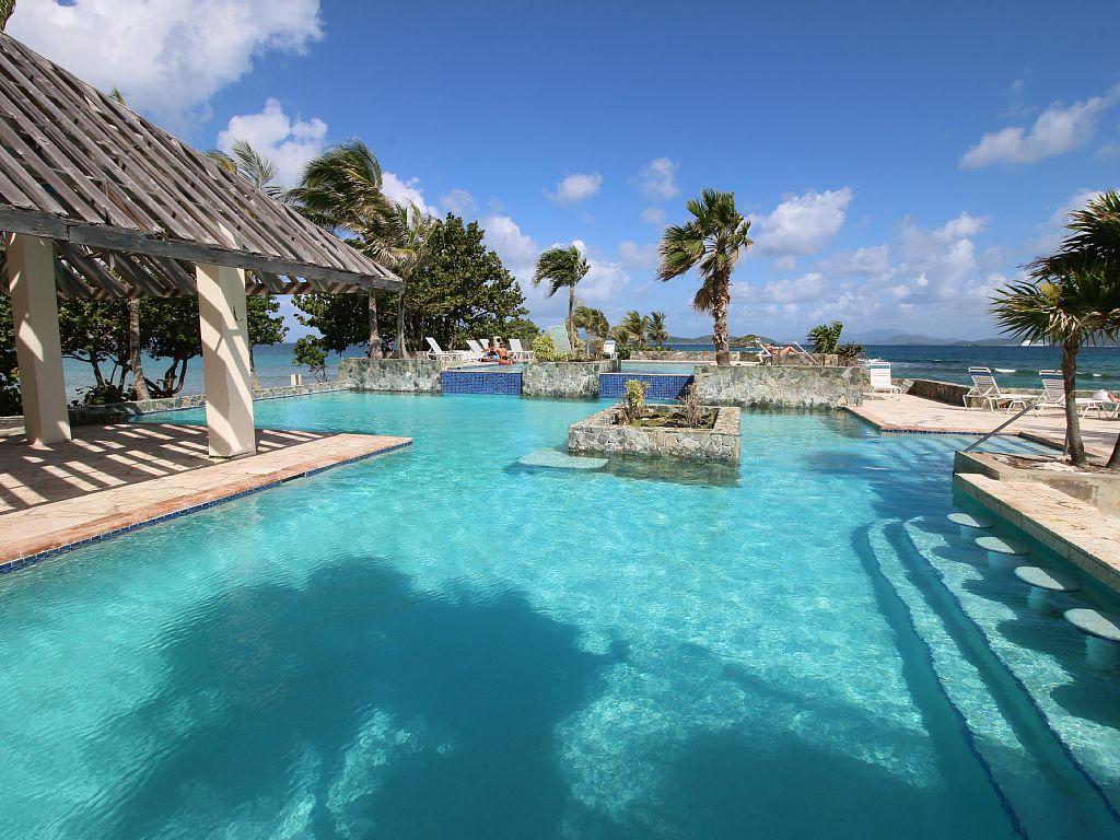 Relax in the pool with cascading waterfall surrounded by lush landscaping.