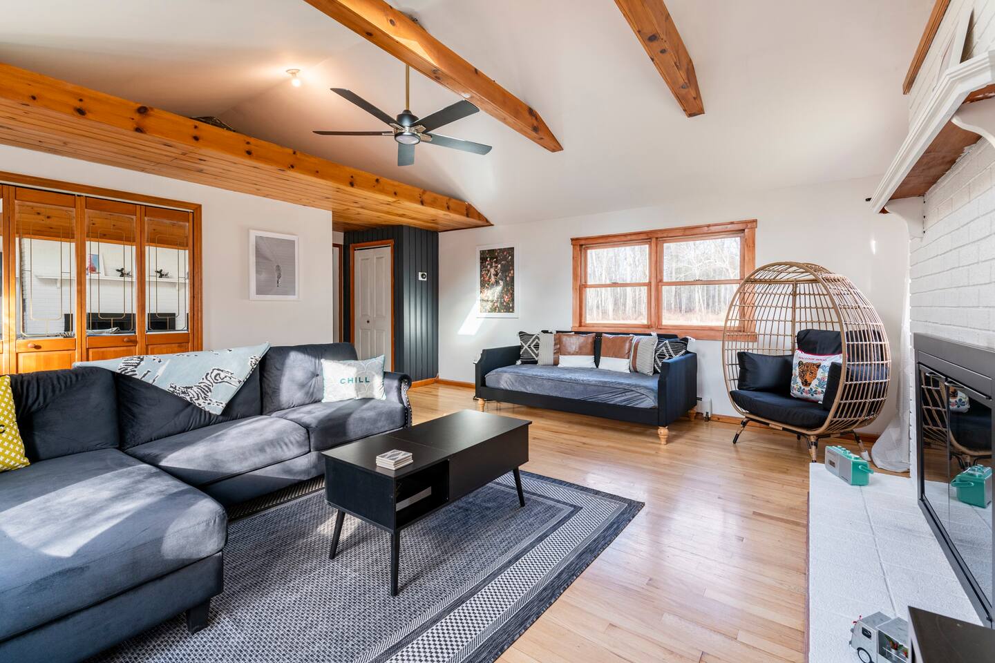 Living room with working fireplace. Relax with your friends and family by a nice fire or watching TV. Daybed

Sectional, daybed and wicker chair (can seat two) makes for a great setting to relax with family and friends.

Coat closet pictured in back.