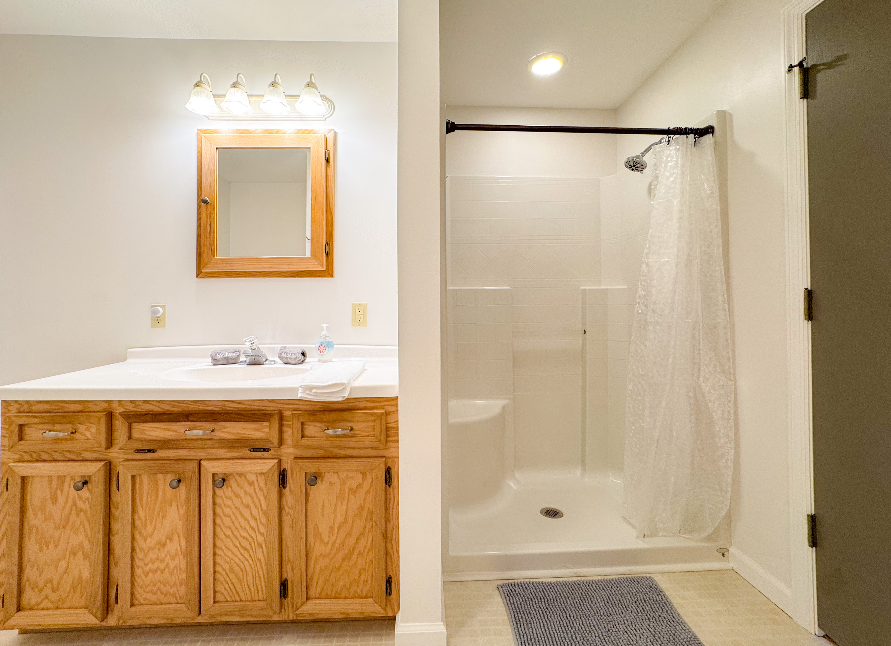 The ensuite bathroom features a tub/shower combination, toilet, vanity, grab bars, and a separate stall shower with low clearance! A rare treat!