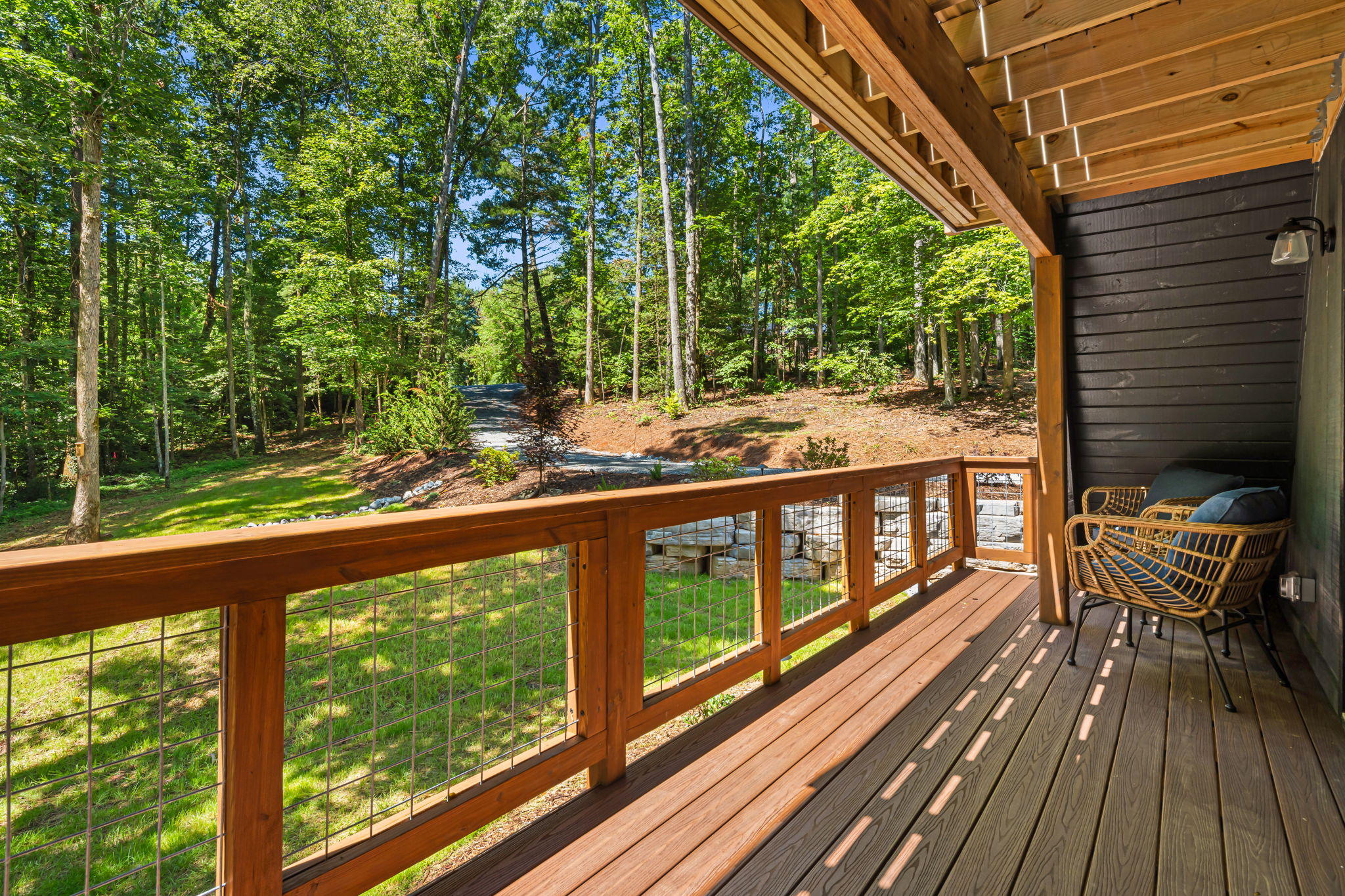 A balcony off the first floor bedrooms is accessible through french doors. Comfortable wicker chairs with a side table make it a perfect spot for morning coffee or afternoon cocktails. A great place to watch the birds and fireflies.