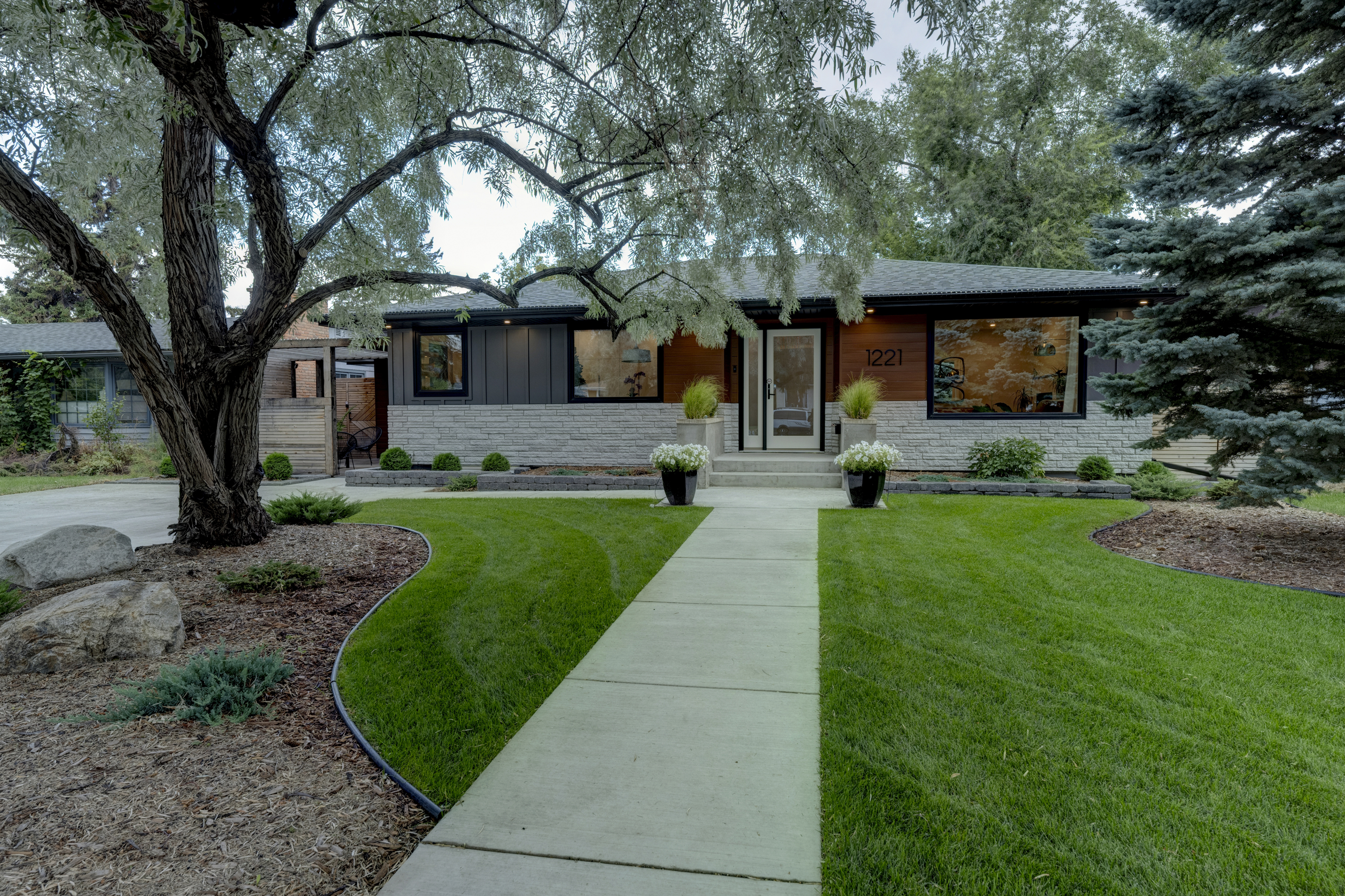 Exterior of the home — the guest suite entrance is through the pergola on the left.