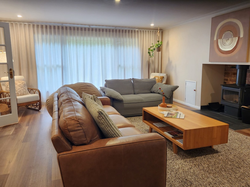 The large lounge area features a wood-burning fire
