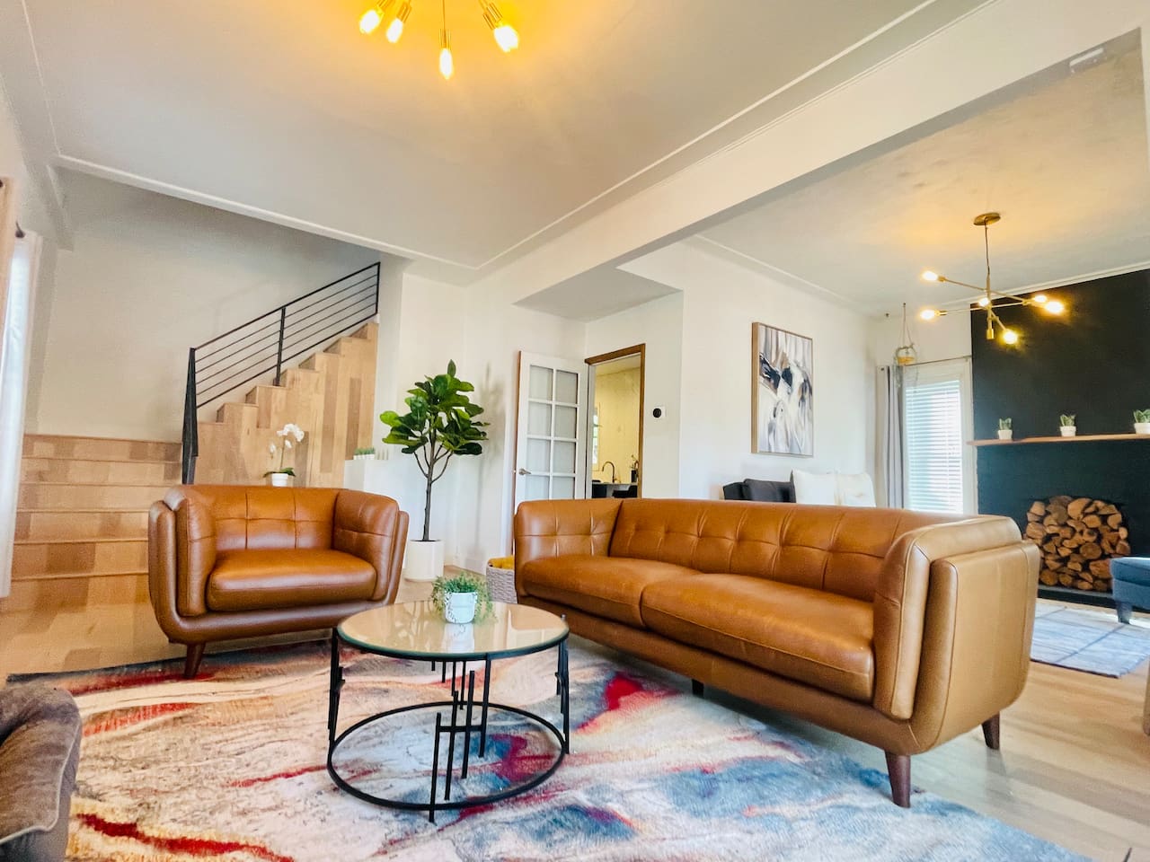 With 10-foot ceilings, an open layout, and buttery leather sofas, this living room was made for unwinding — whether it’s morning coffee or a movie night with friends.